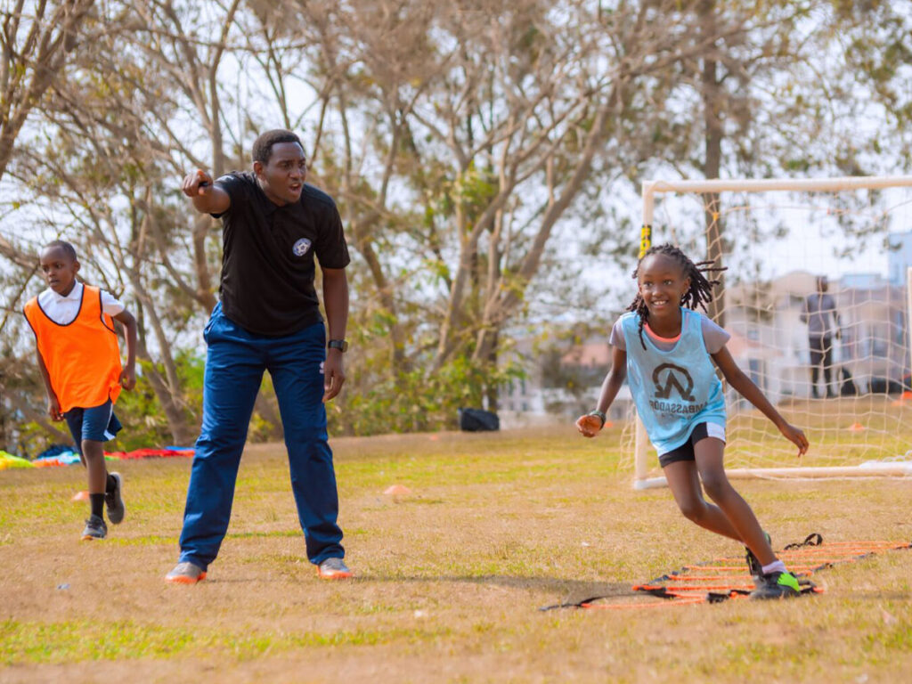 coach instructing girl at the Academy in Rwanda