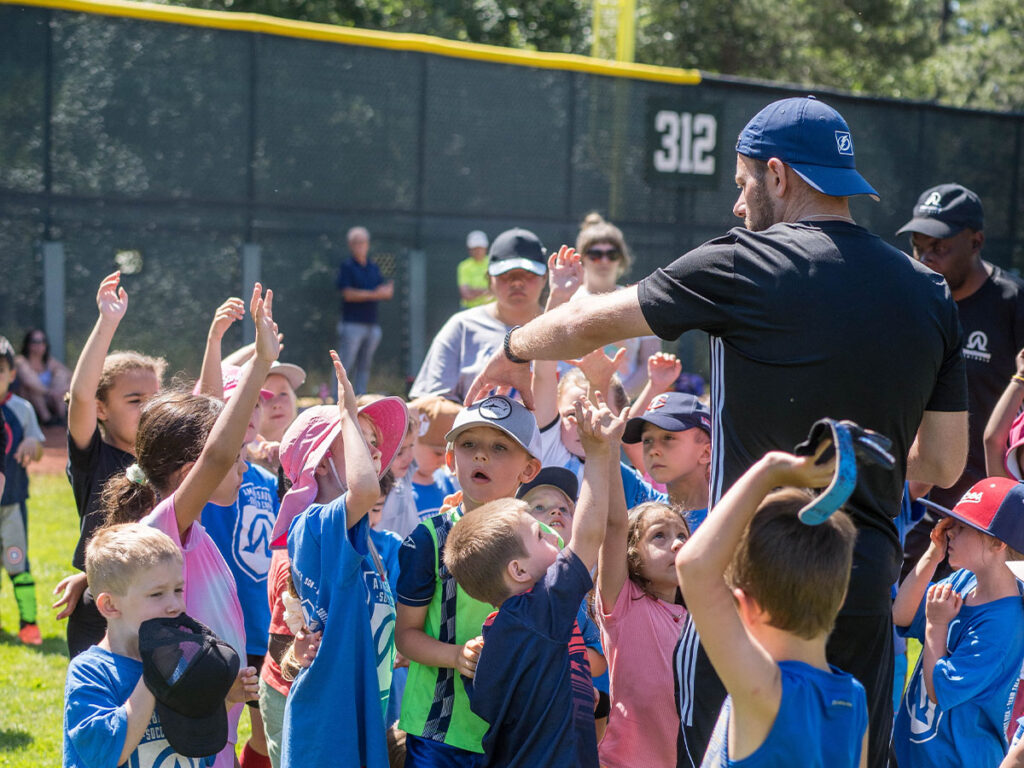 coach interacting with kids at USA football camp