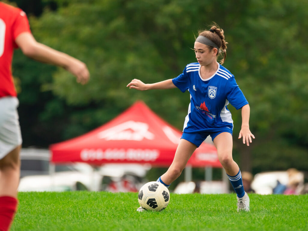girl playing football on Ambassadors Football club team
